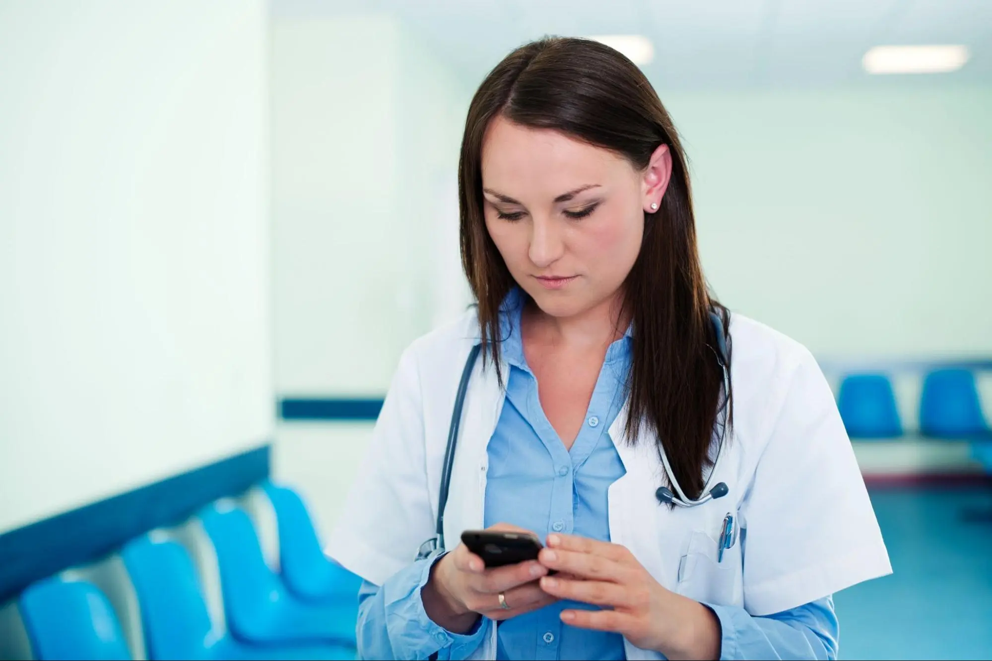 doctor operating mobile device in the hospital