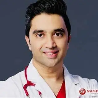Dr. Sameer Arbat, a pulmonologist, in a white coat with stethoscope, smiling for a professional photo