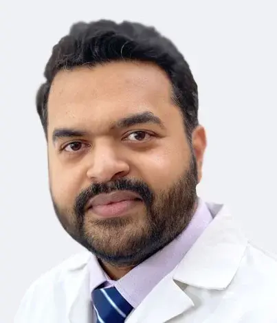 Portrait of a male doctor in a white coat and tie, facing the camera