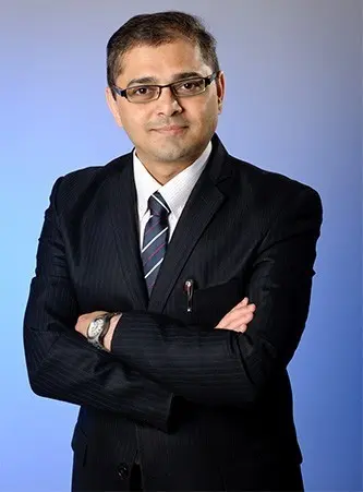 male doctor in formal suit with arms crossed professional portrait