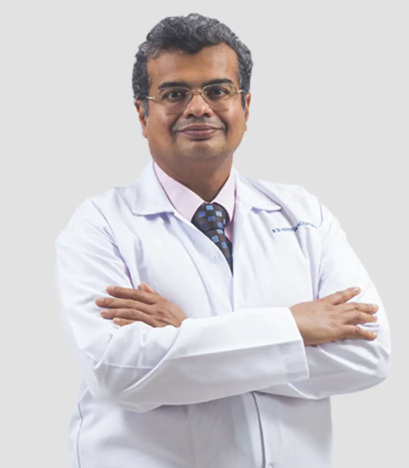 Plastic surgeon in a white coat posing with arms crossed