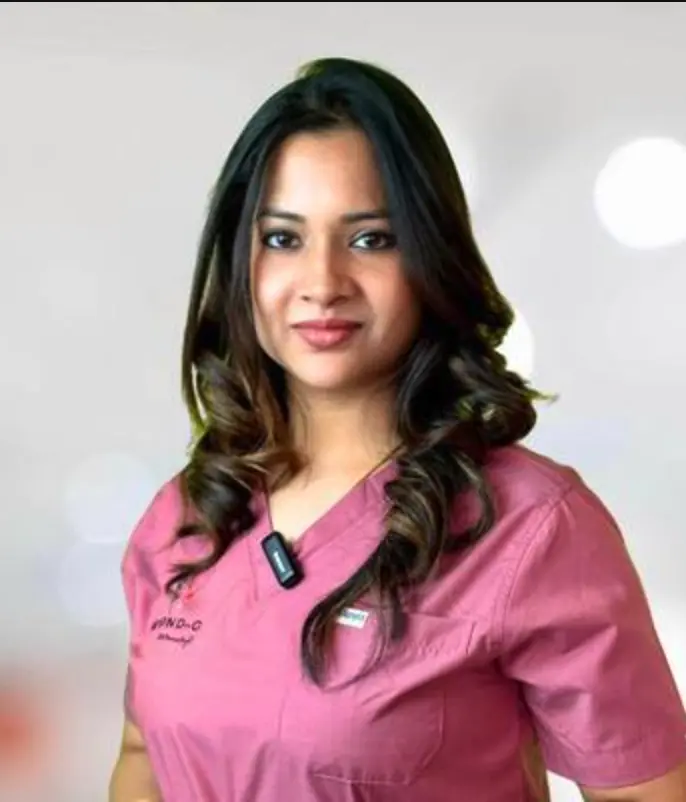 Dr. Mimansa Baghel, gynaecologist and laparoscopic surgeon, in pink scrubs